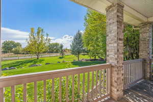 Wooden terrace featuring a yard