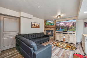 Living room with a fireplace and wood finished floors