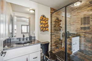 Bathroom featuring a shower stall and vanity