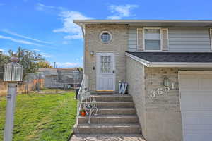 View of front of house with a front lawn and a garage