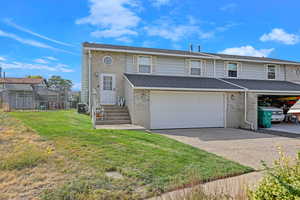 View of front of home featuring a garage and a front lawn