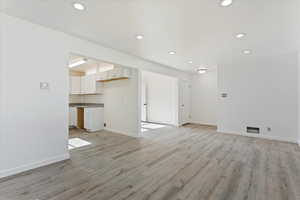 Unfurnished living room with light wood-type flooring