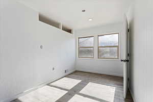 Empty room with light hardwood / wood-style floors