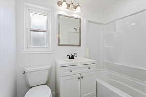 Full bathroom featuring vanity, toilet, and shower / bathtub combination