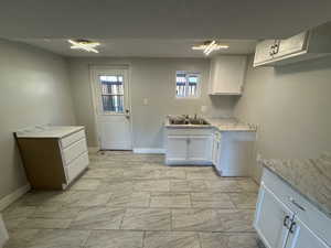 Kitchen with sink and white cabinetry