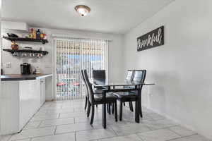 Dining space with a textured ceiling