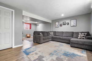 Living room with hardwood / wood-style flooring and a textured ceiling