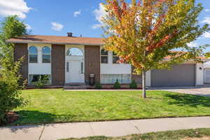 View of front facade with a garage and a front yard