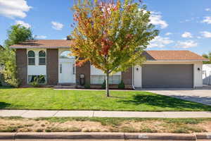 View of front of home featuring a garage and a front lawn