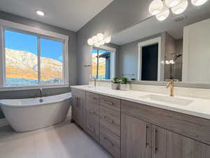 Bathroom with a mountain view, vanity, tile patterned floors, and independent shower and bath