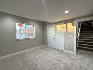 Unfurnished bedroom featuring light carpet