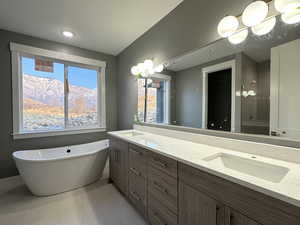 Bathroom featuring a mountain view, vanity, and separate shower and tub