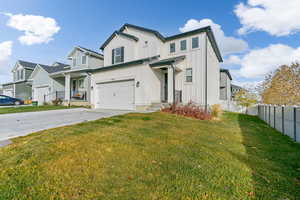 View of front facade with a front yard and a garage