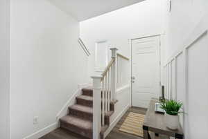 Stairway featuring wood-type flooring