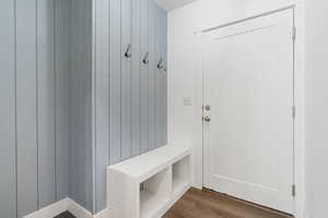 Mudroom featuring wooden walls and dark hardwood / wood-style floors