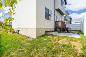 View of side of home with a lawn