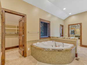 Primary bathroom with his walk-in closet