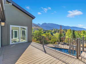 Main floor deck accessed from Primary Bedroom and Great Room with mountain views