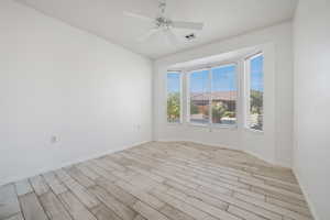 Empty room featuring ceiling fan and light hardwood / wood-style floors