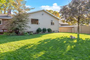 View of property exterior featuring a lawn