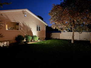 Property exterior at twilight featuring a yard