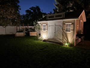 View of outbuilding with a lawn