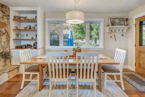 Dining area with hardwood / wood-style flooring and a textured ceiling