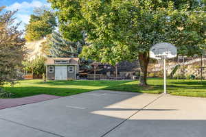 View of patio / terrace featuring basketball hoop and an outdoor structure