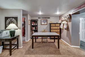 Office space featuring carpet floors and a textured ceiling