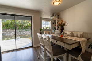 Dining area featuring ornamental molding, hardwood / wood-style flooring, and a textured ceiling