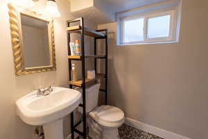 Bathroom with tile patterned flooring, sink, a textured ceiling, and toilet