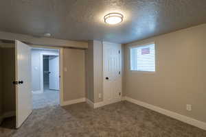 Interior space with a textured ceiling, a closet, and carpet flooring