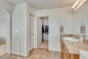 Primary bathroom and walk-in closet. Bountiful space to store all your clothing and necessities.