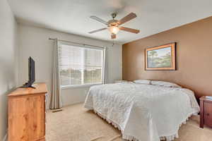 Primary bedroom with ceiling fan