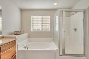 Primary En Suite with separate tub and shower. A private oasis to recharge.