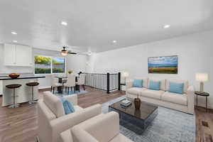 Living room featuring ceiling fan and light hardwood / wood-style flooring