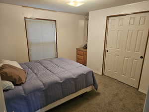 Bedroom with carpet flooring and a textured ceiling