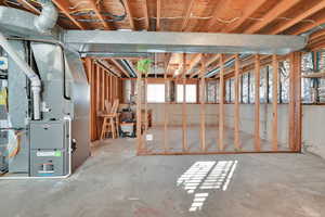 Unfinished area of basement with updated furnace.