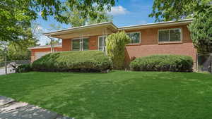 Ranch-style home featuring an attached garage and brick siding