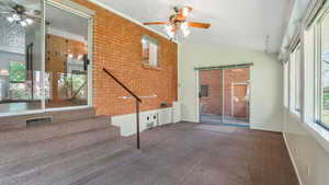 Unfurnished sunroom with vaulted ceiling and healthy amount of natural light
