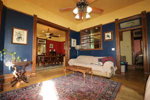 Living room with hardwood / wood-style floors and ceiling fan