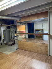 Basement featuring gas water heater and hardwood / wood-style floors