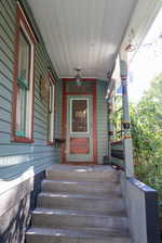 Doorway to property featuring a porch