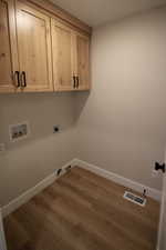 Washroom featuring washer hookup, cabinets, gas dryer hookup, large linen closet, and electric dryer hookup