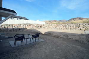 View of yard with a mountain view and a patio area