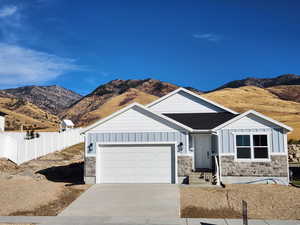 View of front of property featuring a mountain view and a garage