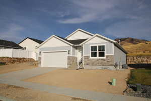 Craftsman inspired home featuring a garage and central AC