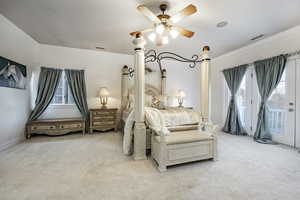 Bedroom featuring crown molding, access to outside, and light colored carpet
