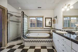 Bathroom with visible vents, a bath, a wealth of natural light, and a shower stall