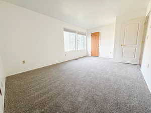 Empty room featuring carpet flooring